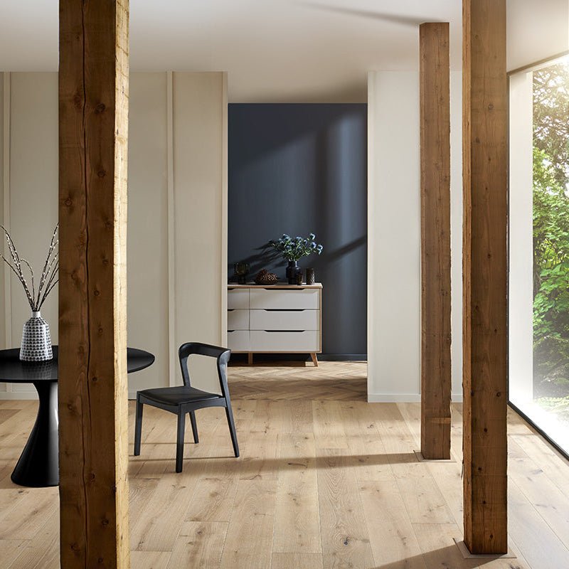 Black plastic harlech chair with sleek modern design and curved backrest in white smoked oak setting