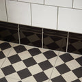 Black glossy diamond patterned tile trim from harlequin large black on chalk collection for decorative edging