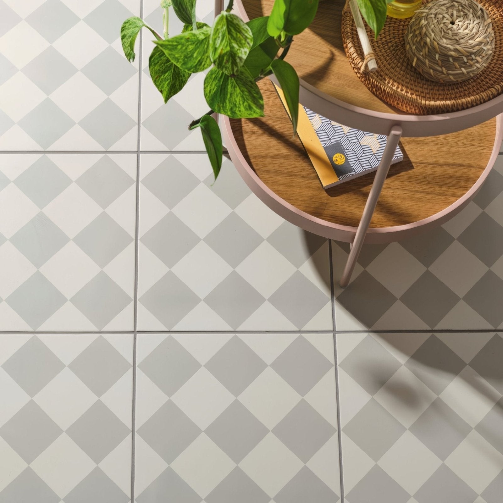 Harlequin large grey ceramic floor tiles with gray and white diamond pattern on chalk background