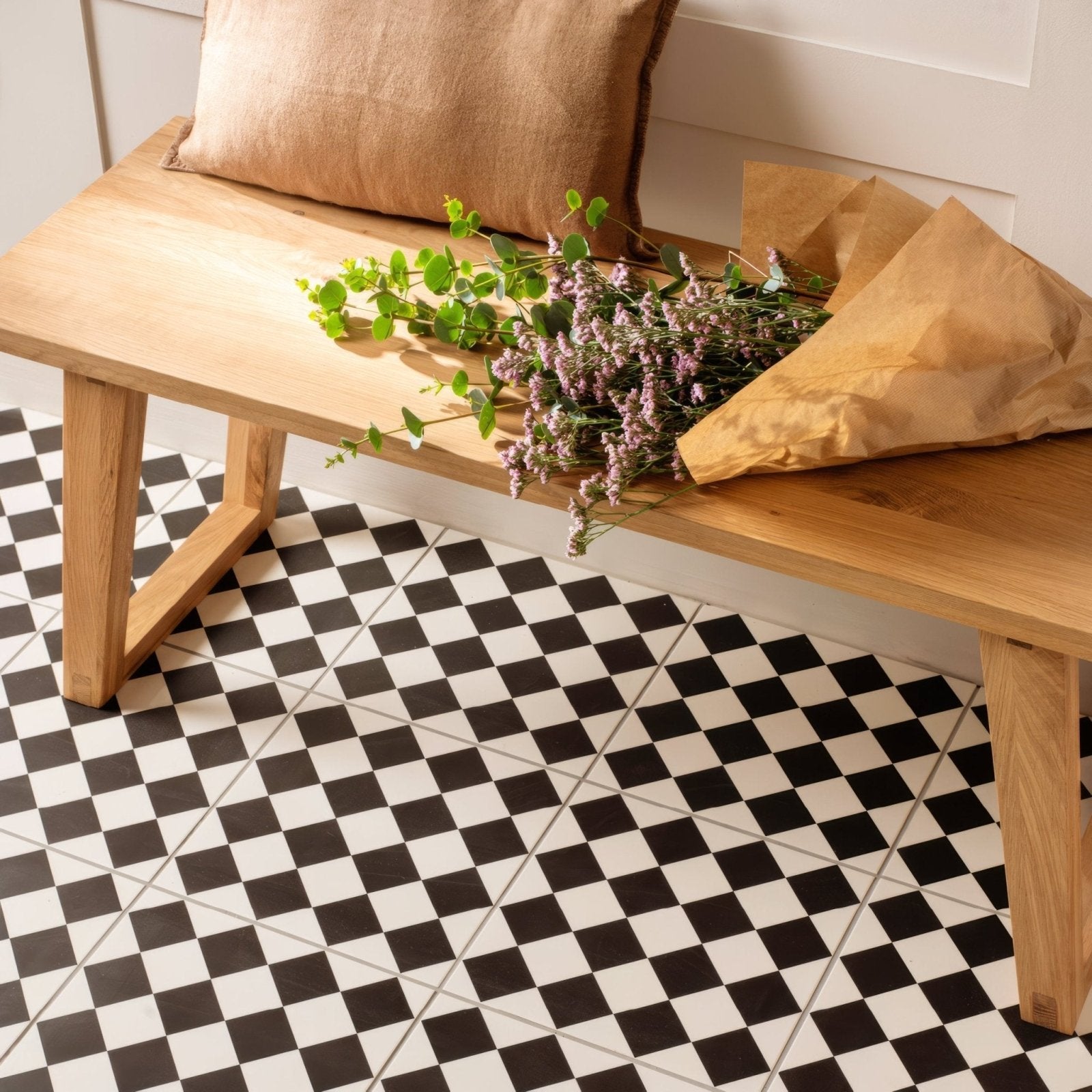 A rustic wooden bench with natural finish and simple sturdy legs in harlequin small black on chalk design