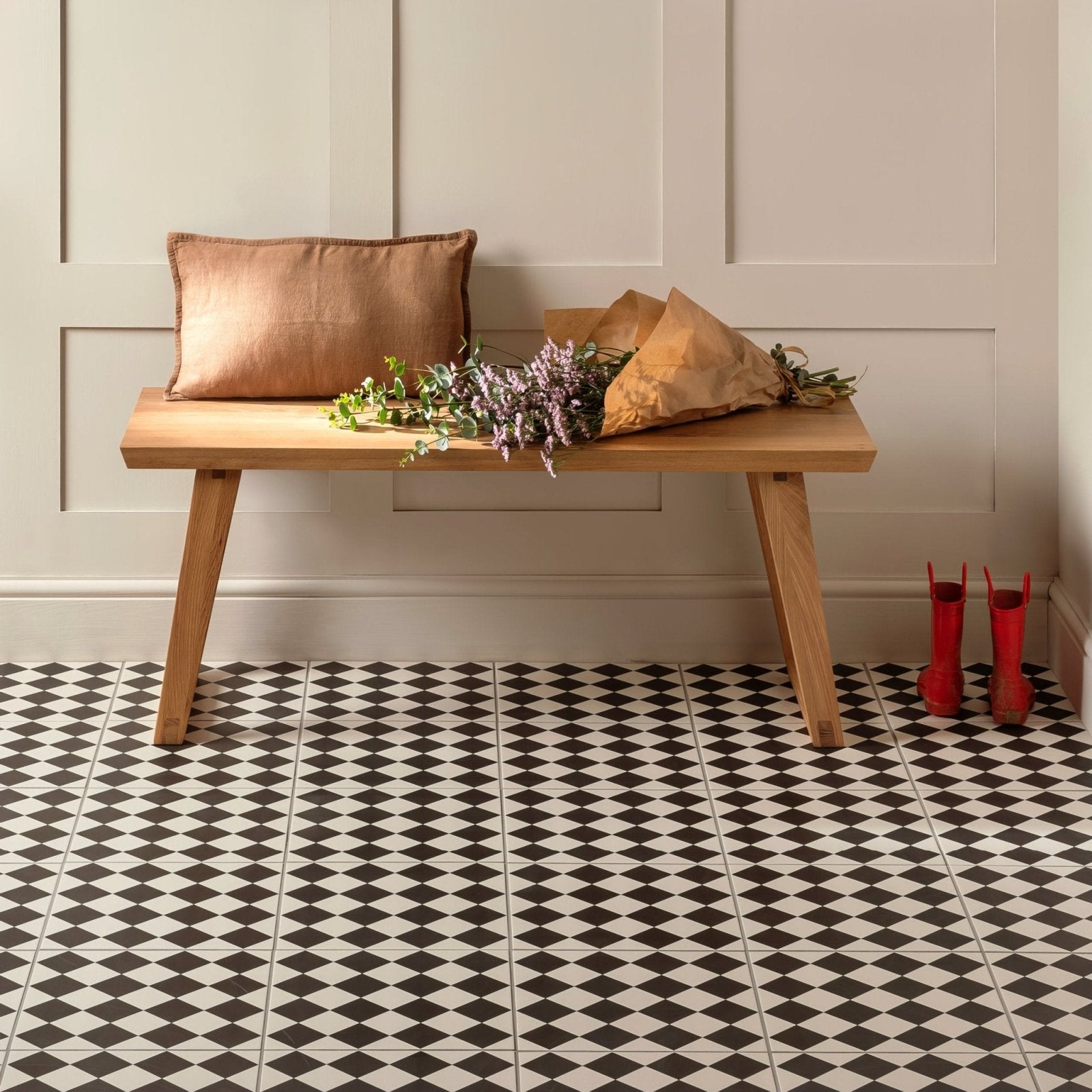 Light wood bench with angled legs and natural finish featured in harlequin small black on chalk product line