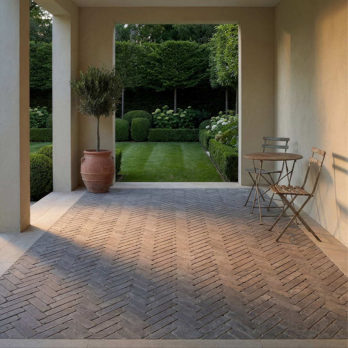 Terracotta herringbone patterned brick patio made from hazlebury limestone tumbled and etched klinkers