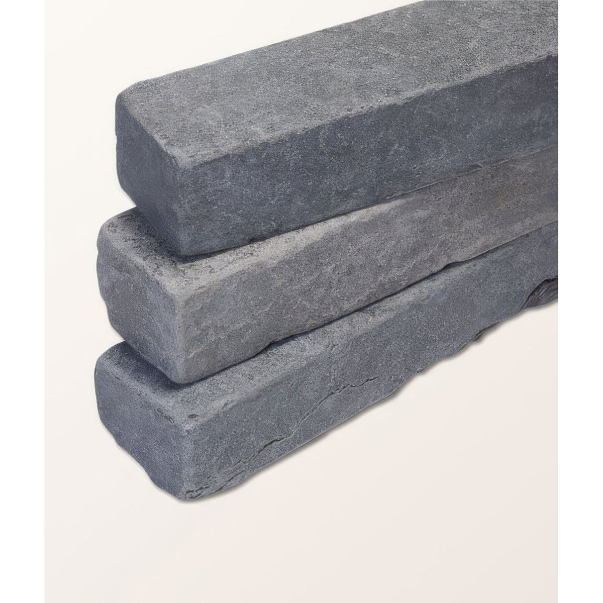 Stacked dark gray hazlebury limestone tumbled and etched klinkers with a rough textured surface for outdoor paving