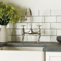 Shiny chrome helmingham half tile kitchen faucet with two cross-handle knobs and bridge-style design