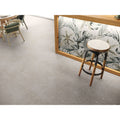 Helsinki 1841 Gris grey porcelain floor tiles with a wooden stool