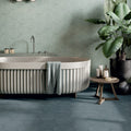 A modern freestanding hexagon blue plain bathtub with a ribbed off-white exterior and smooth interior