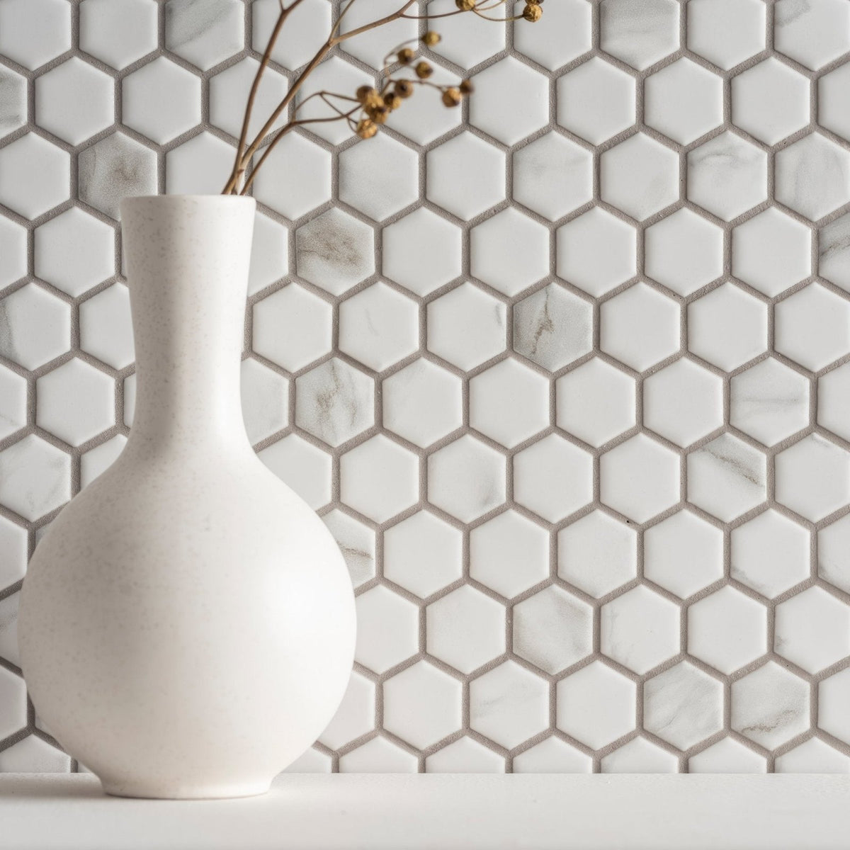 Hexagon Matt Carrara White white marble hexagon mosaic with a matte white ceramic vase