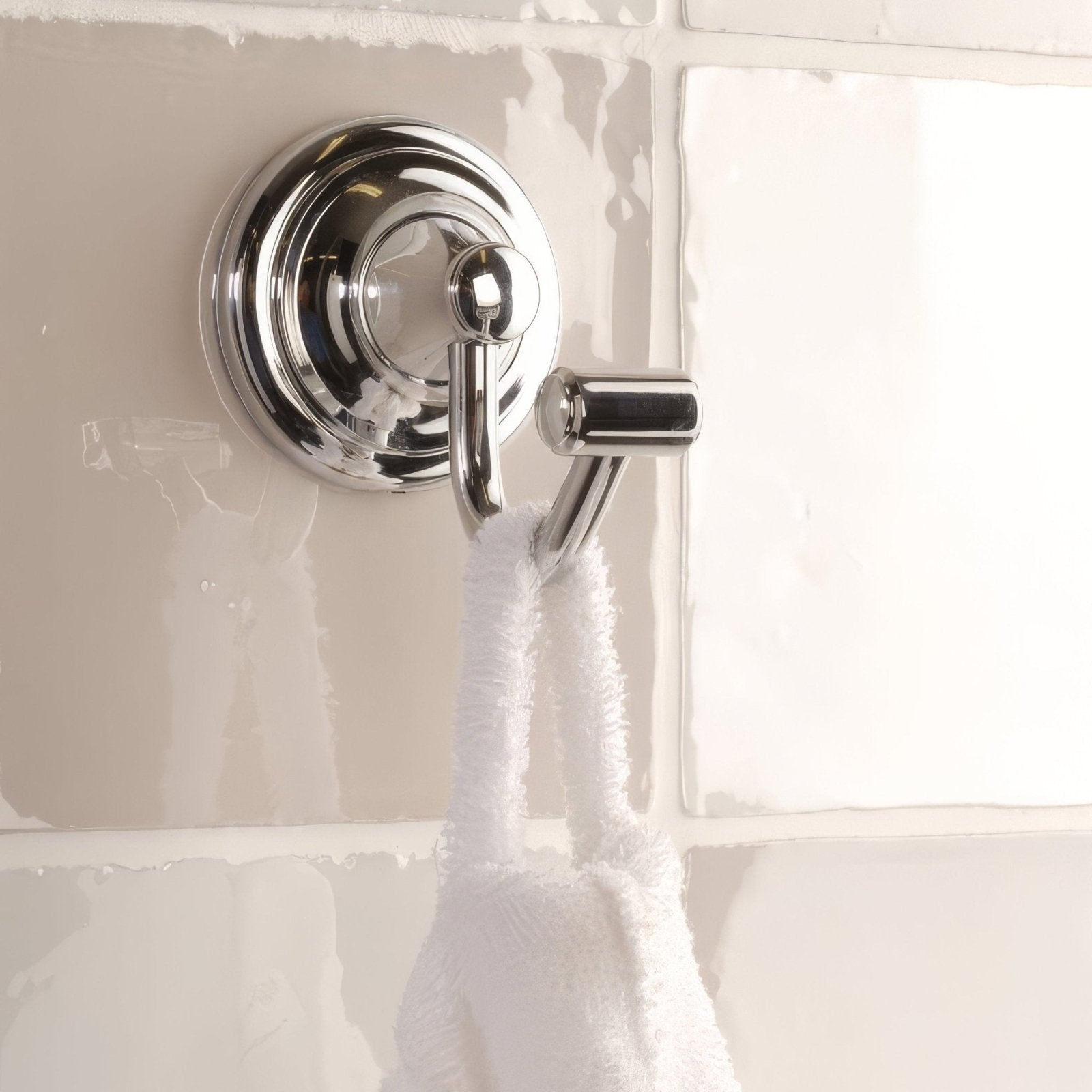 Chrome-finished double towel hook with sleek circular base and polished metal finish featured on hibiscus field tile