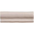 Beige ceramic hibiscus torus moulding tile with smooth glossy finish and subtle wavy ridges along its length