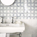 High Society Marble Guggenheim white marble mosaic with a marble sink, chrome taps and towel rack