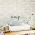 High Society Marble Rockefeller white marble hexagon mosaic backsplash with a marble sink and chrome tap