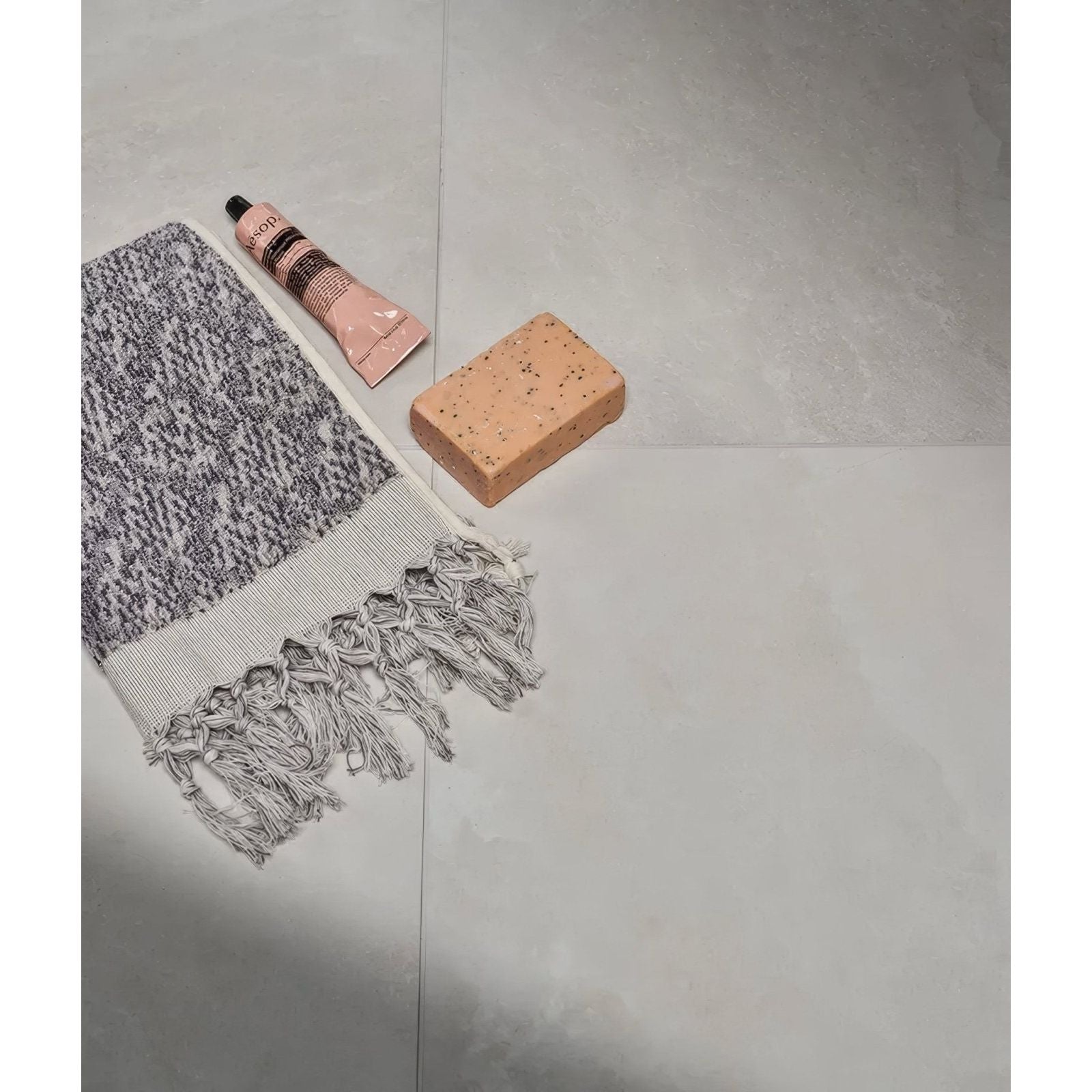 Gray and white textured towel with fringed edges from himalaya porcelain matt crystal collection