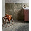 Himalaya Porcelain Matt Fjord beige marble-effect tiles with a wooden stool and orange towel