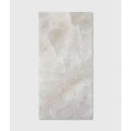 A rectangular light beige marble tile with subtle veining and smooth polished surface from himalaya porcelain matt natural