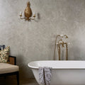 Holland Park Porcelain grey marble-effect tiles with a freestanding bathtub and patterned towel