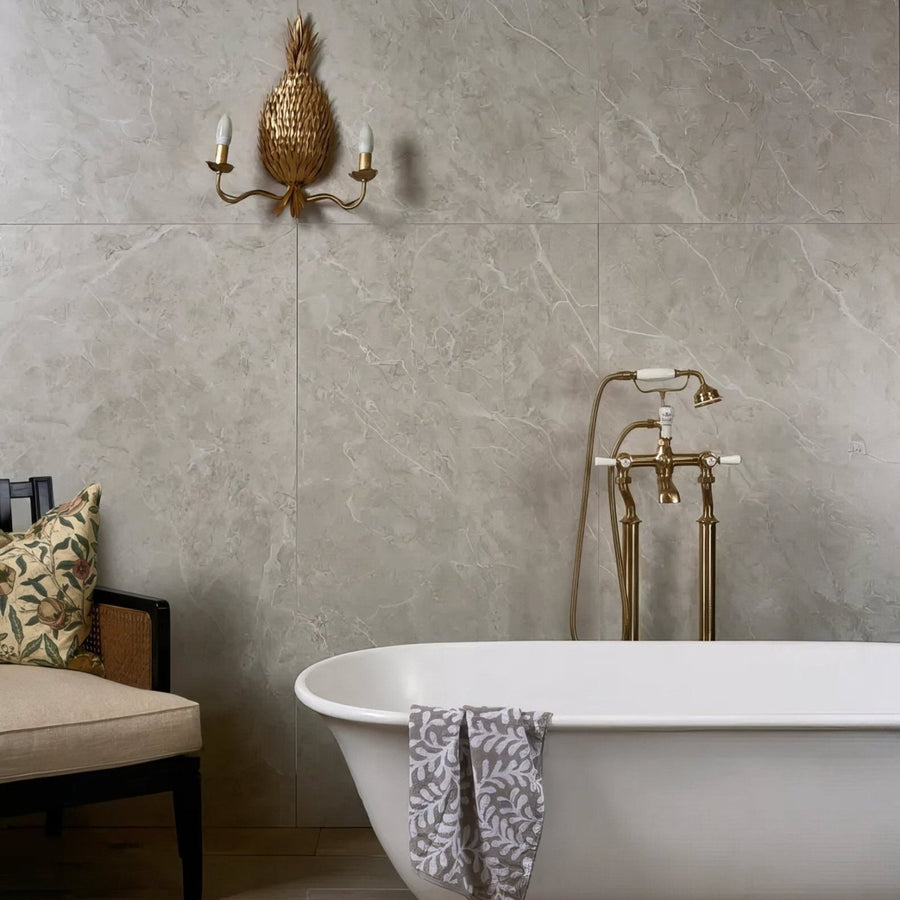 Holland Park Porcelain grey marble-effect tiles with a freestanding bathtub and patterned towel