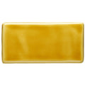 A smooth rectangular ceramic honey half tile with a glossy mustard yellow glaze for wall and floor use