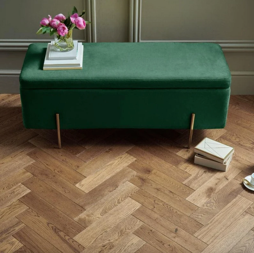 Goodrich Coffee Oak herringbone wood flooring beneath a green velvet bench