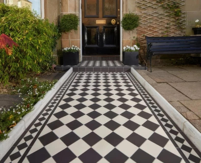 Black and white Victorian chequerboard path leading to a front door