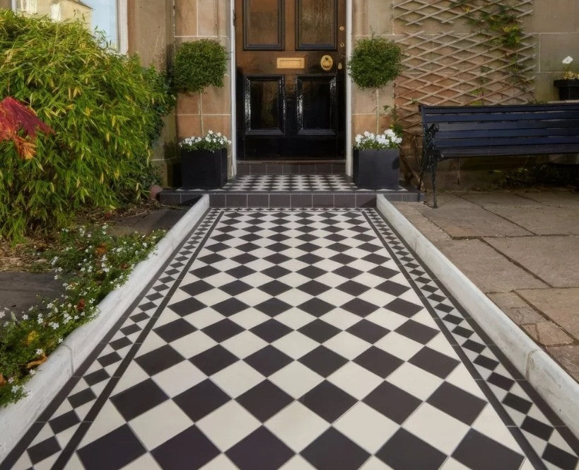 Black and white Victorian chequerboard path leading to a front door