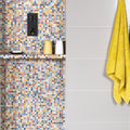 A vibrant ibiza porcelain mosaic wall featuring colorful multicolored small square tiles in a vibrant pattern