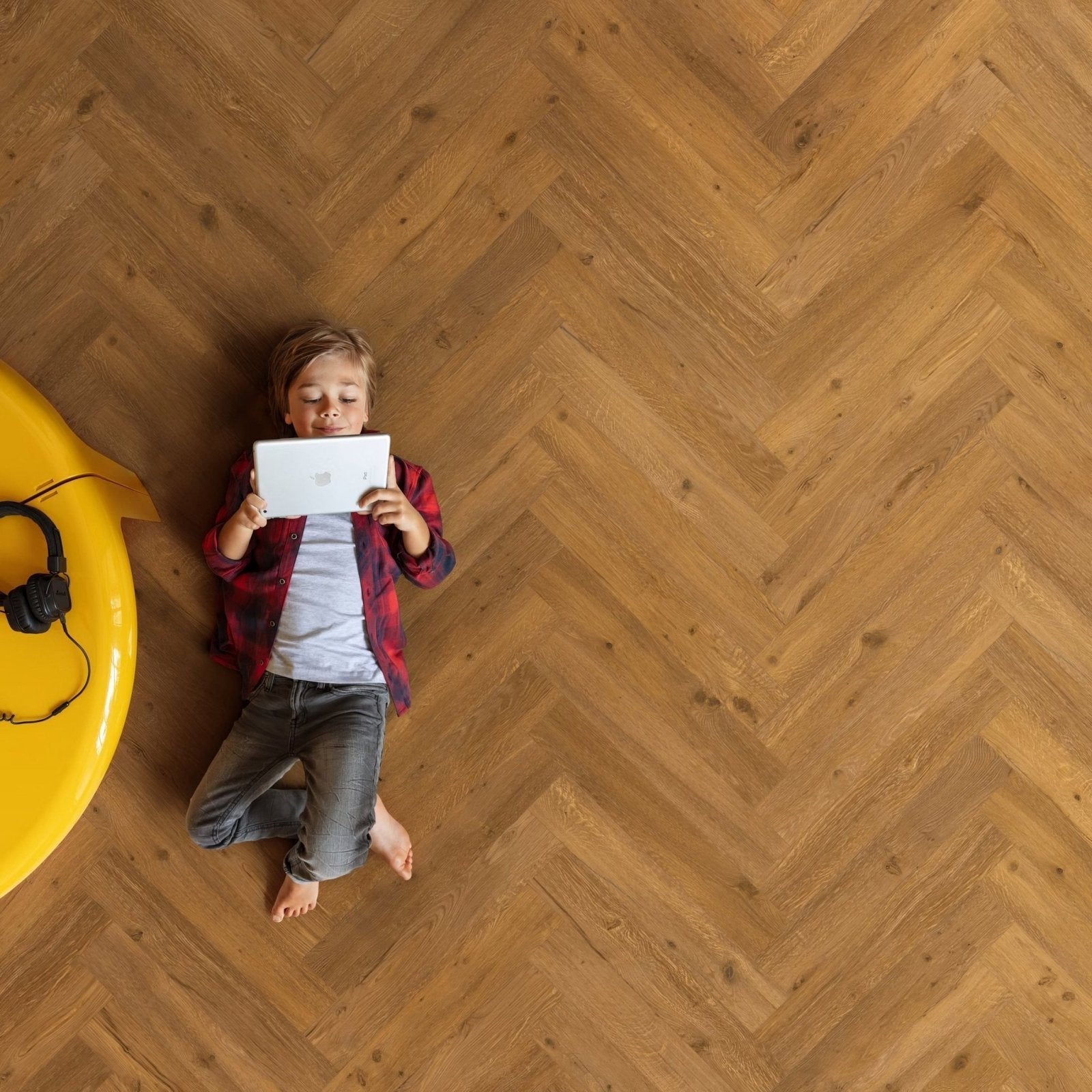 Child holding a white tablet featuring the ikura f333 vinyl herringbone textured cover design