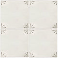 Off-white ceramic tiles with black hand-painted leaf motifs at each corner from imprint delft corners collection
