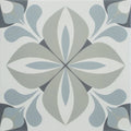 A square ceramic infusion lousa patterned tile with a symmetrical stylized floral pattern in shades of gray and white