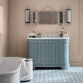 Light blue painted bathroom vanity with white marble countertop and silver hardware featuring infusion nazare patterned tile