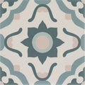 A square ceramic tile featuring a symmetrical ornate floral pattern in muted teal soft pink and cream tones infusion nazare patterned tile