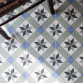 Infusion Ribeira patterned ceramic floor tiles with geometric star design in shades of gray blue and white