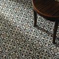 Infusion st etienne patterned ceramic floor tile with repeating quatrefoil design in dark gray teal blue and off-white