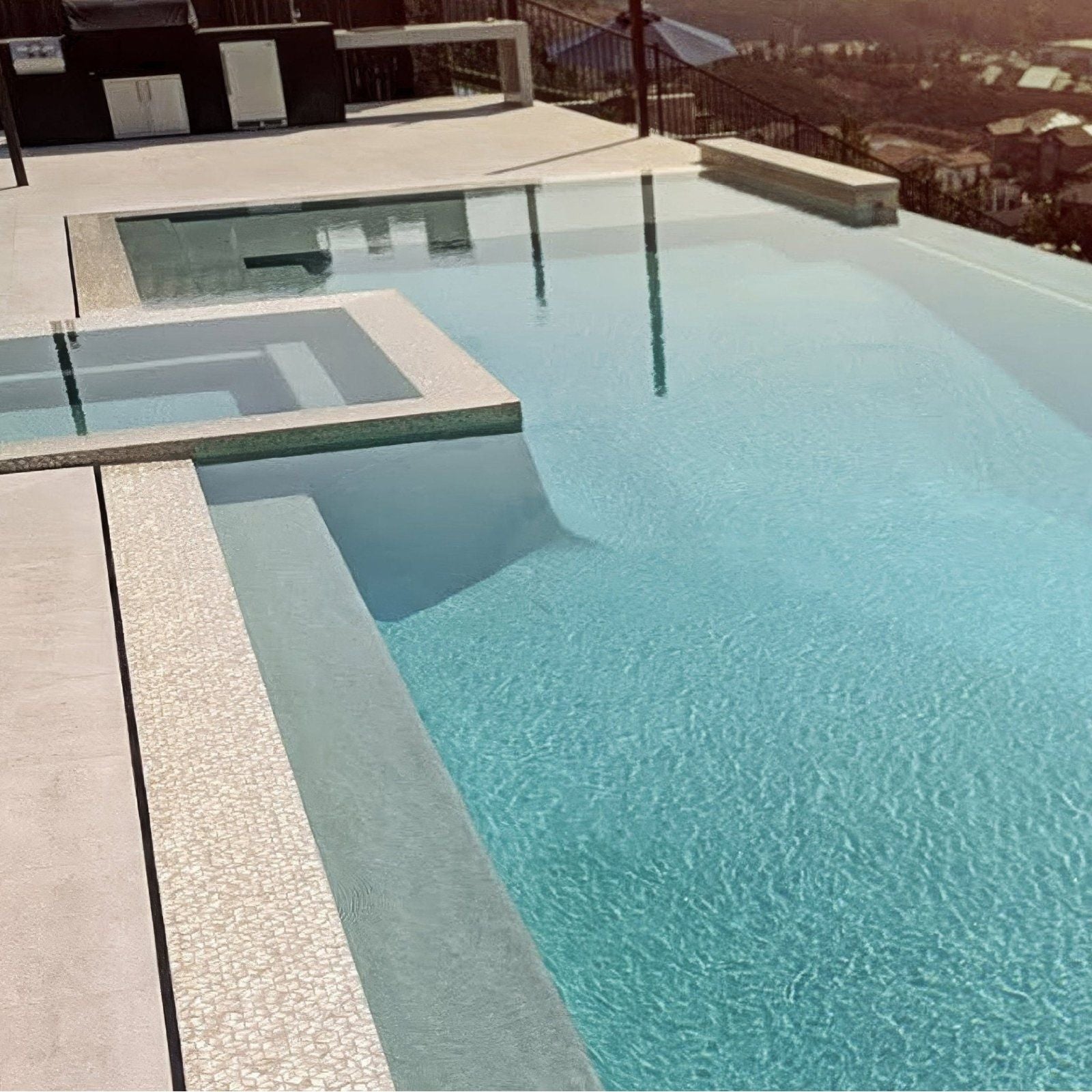 Innocence 25mm Square mother-of-pearl mosaic lining an infinity-edge swimming pool