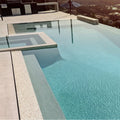 Innocence 25mm Square mother-of-pearl mosaic lining an infinity-edge swimming pool