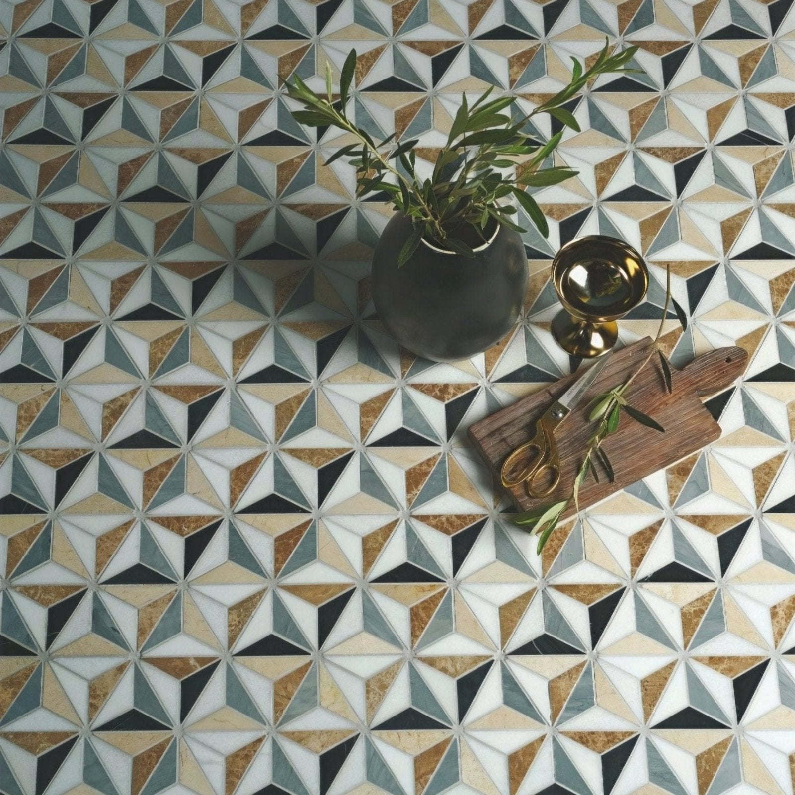Geometric mosaic tile floor with interlocking triangles in white beige gold and dark gray tones from Istanbul Marble Mosaic