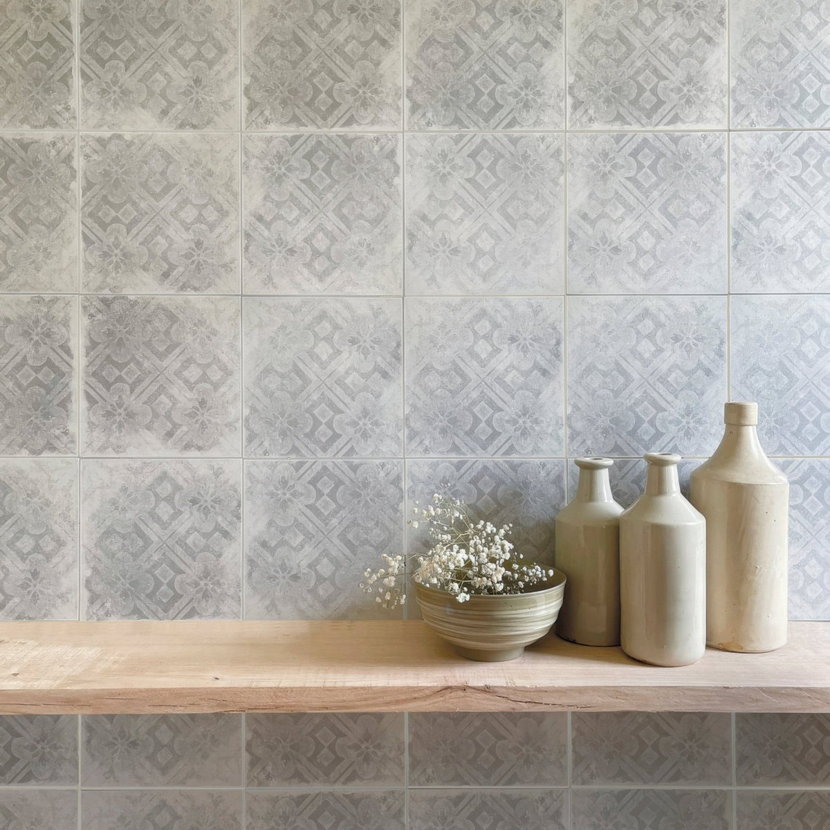 Beige ceramic bottles with matte finish and subtle geometric design inspired by istria pula patterned tile