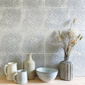 Istria Pula patterned tile with matte gray ceramic vase featuring vertical ridges holding dried pampas grass