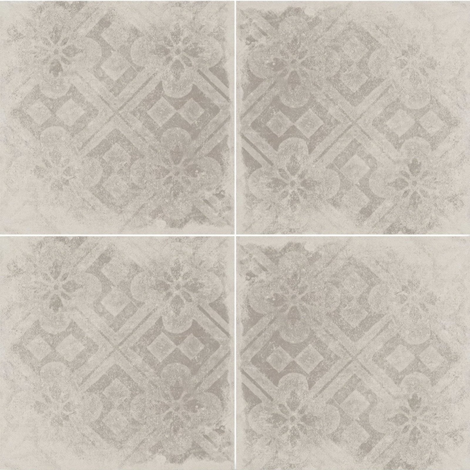 Four square tiles of istria pula patterned tile with muted gray distressed floral and geometric design