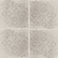 Four square tiles of istria pula patterned tile with muted gray distressed floral and geometric design