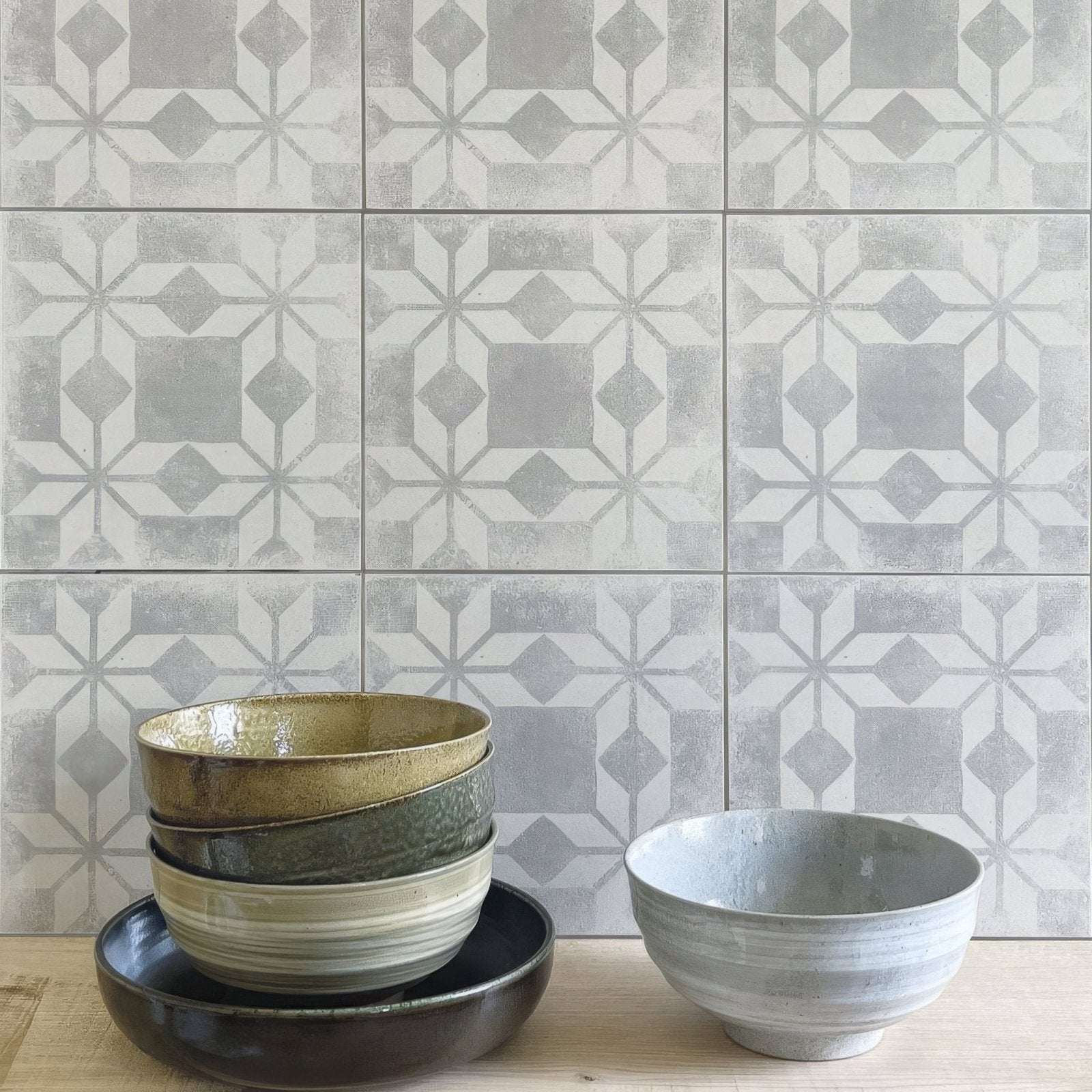 Stack of earth-toned ceramic bowls with subtle glaze and textured rims inspired by istria ravni patterned tile design