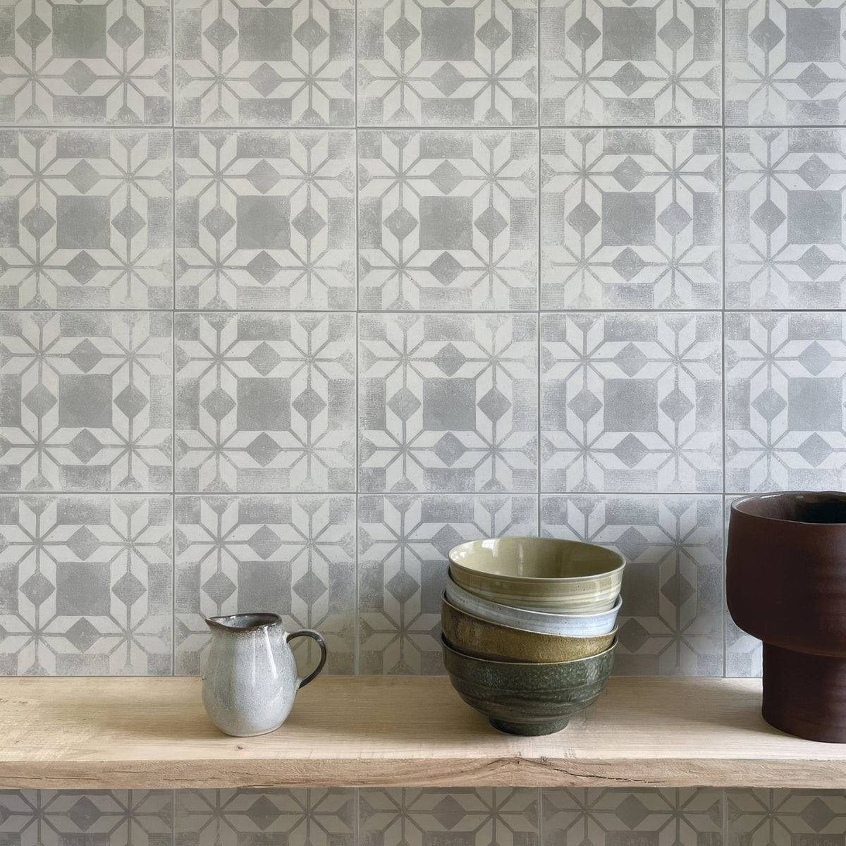 Stack of ceramic bowls in earthy tones with subtle glaze finishes inspired by istria ravni patterned tile design