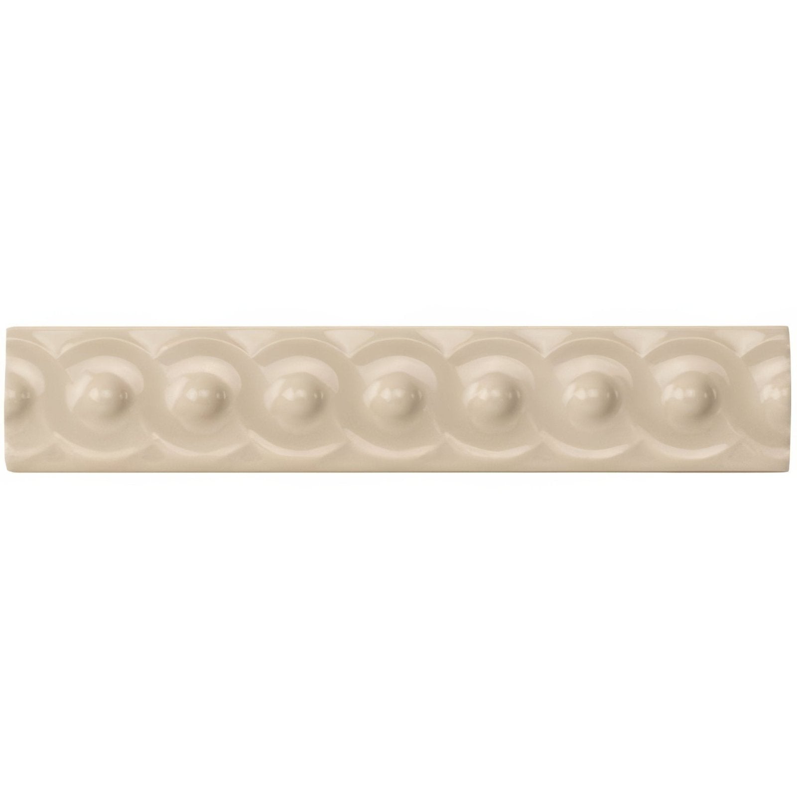 Ivory scroll moulding ceramic tile with cream color and a repeating pattern of raised rounded beads