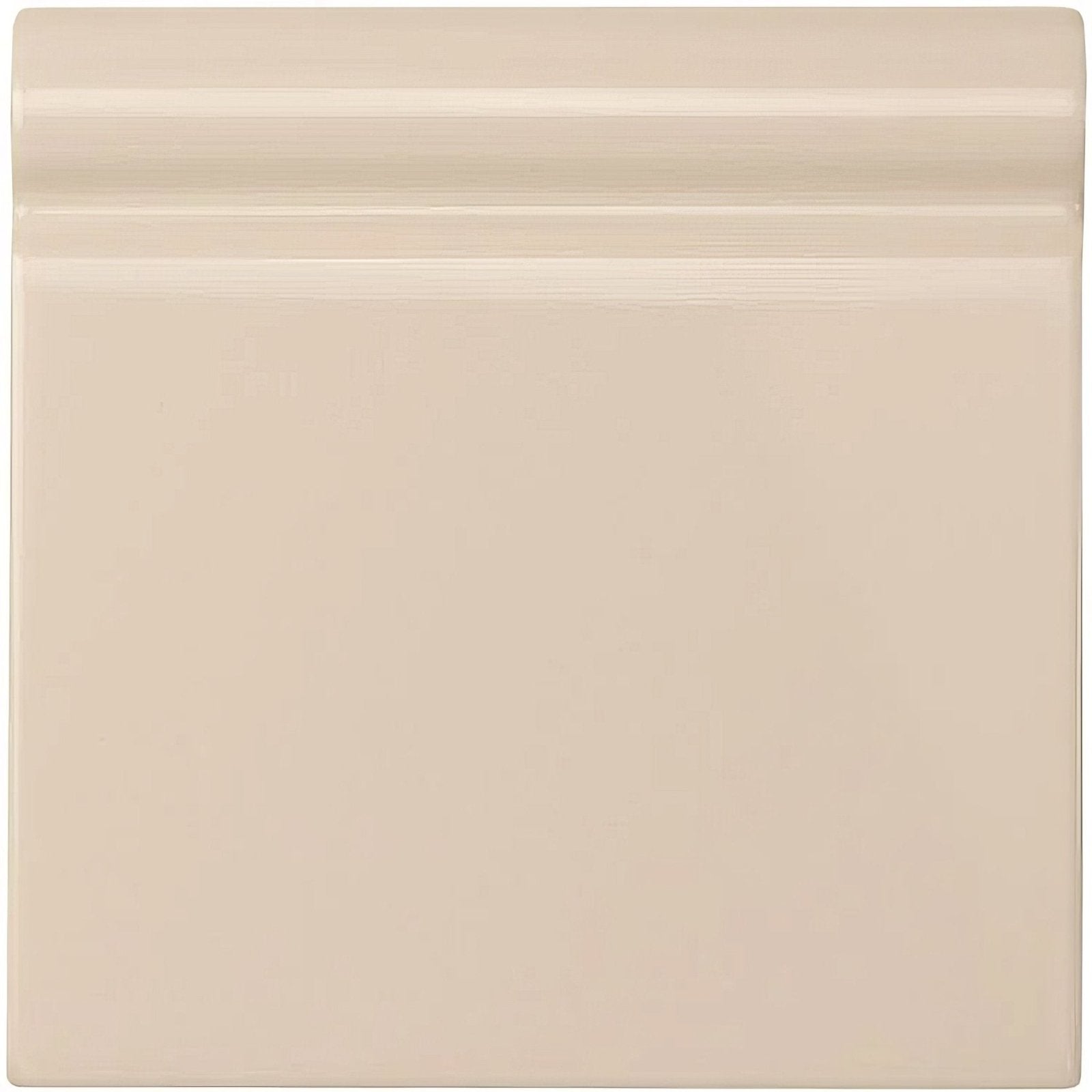Ivory skirting tile made of beige ceramic with a smooth glossy finish and subtle horizontal ridges on the top edge