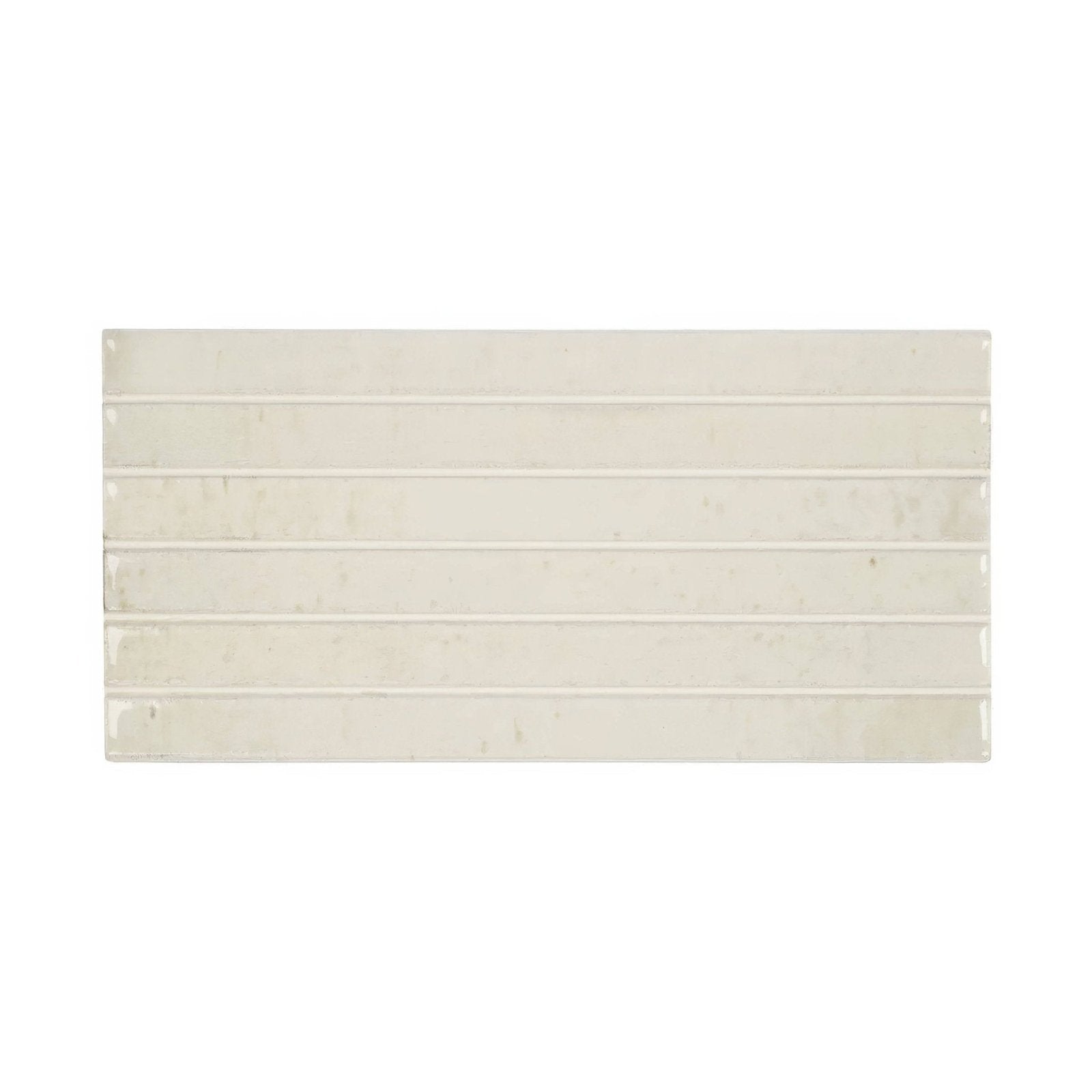 Cream-colored ixworth bone bar tile with subtle glossy finish and faint veining arranged in horizontal rectangular strips