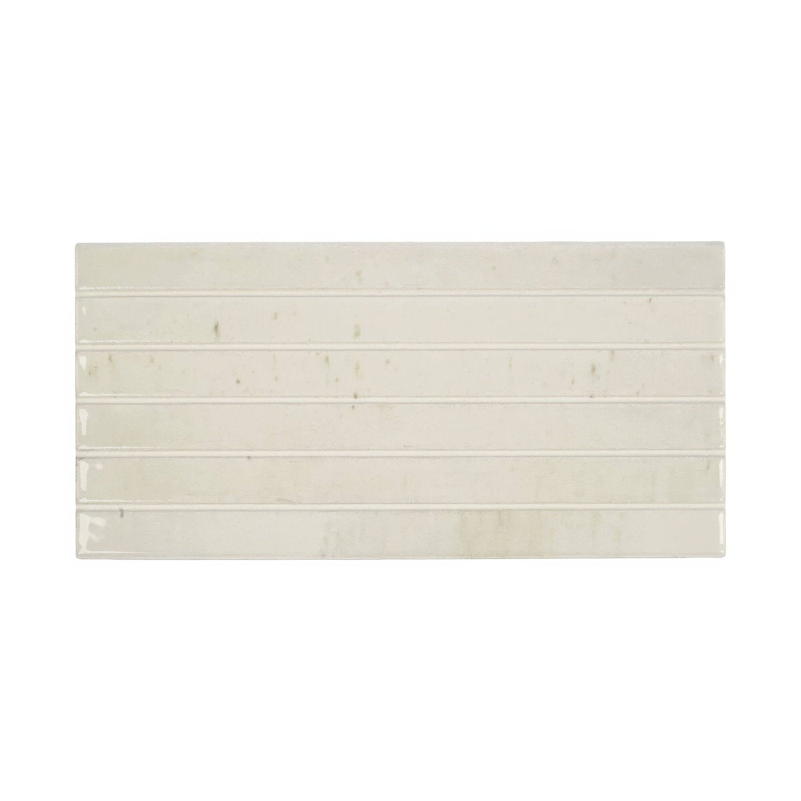 Cream-colored rectangular ixworth bone bar tile with horizontal grooves and subtle marbled texture for wall use