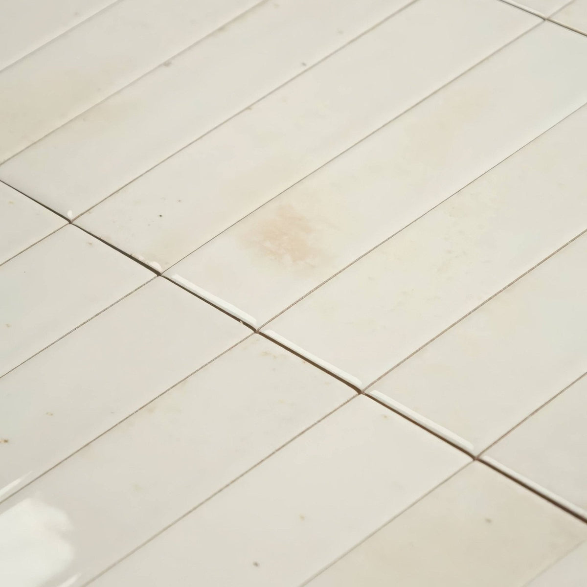 Off-white rectangular ceramic ixworth bone brick floor tiles with subtle grout lines for indoor flooring