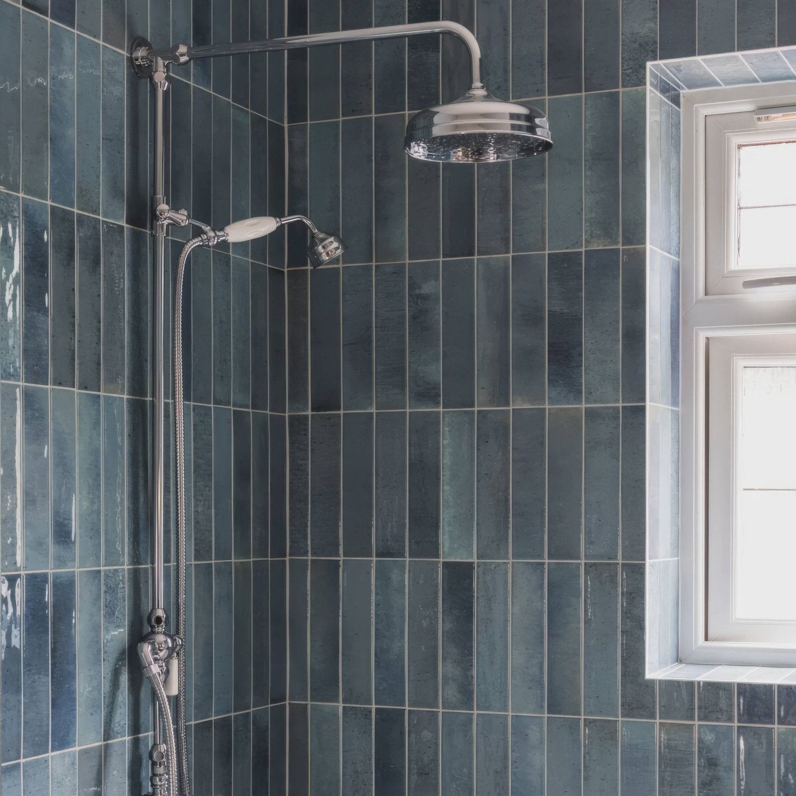 Chrome finished ixworth sky brick tile showerhead with sleek rounded design mounted on adjustable chrome pipe system