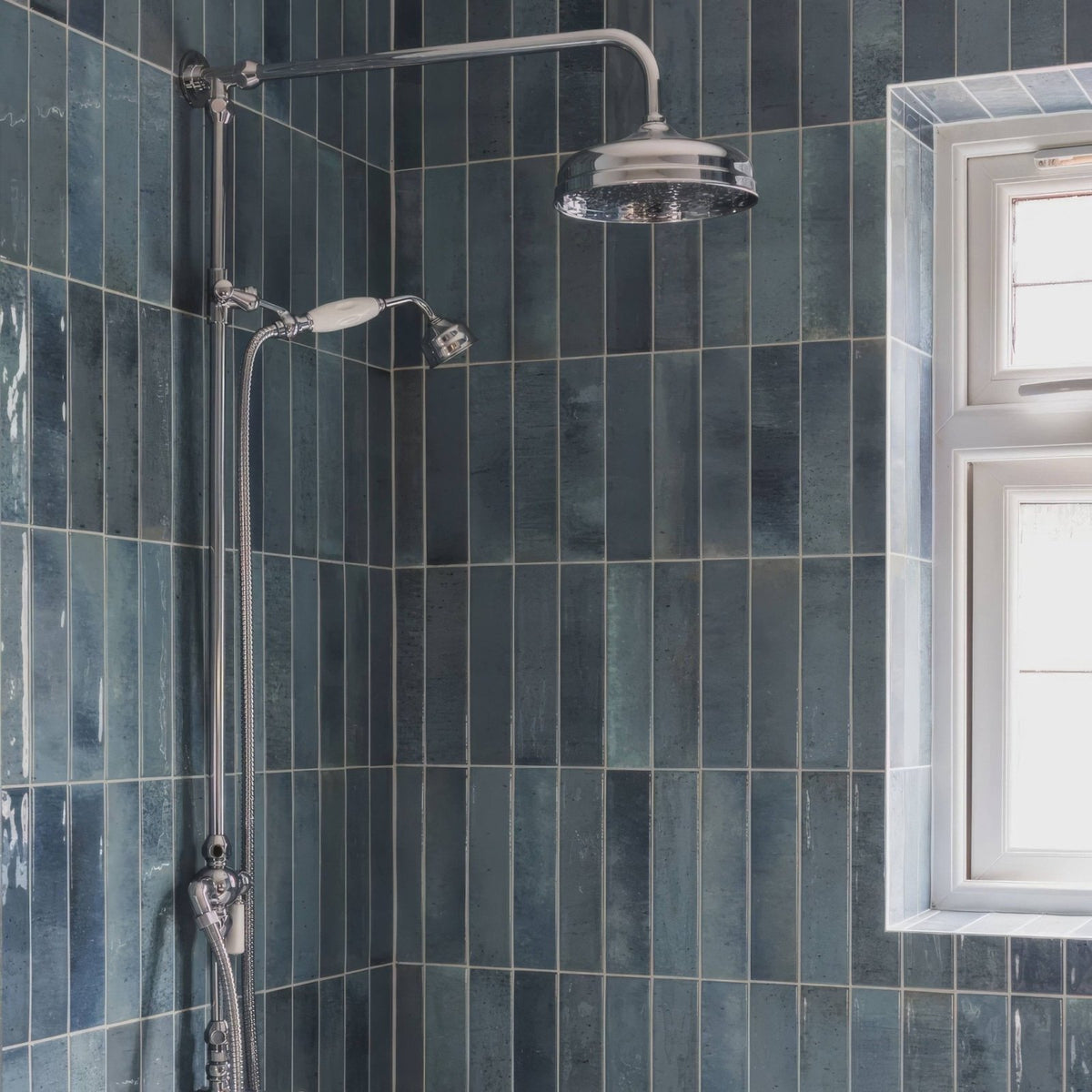 Chrome finished ixworth sky brick tile showerhead with sleek rounded design mounted on adjustable chrome pipe system