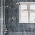 Dark teal glossy ixworth sky brick tile with subtle texture on shower wall for stylish bathroom design