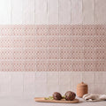 Jacquard clay ceramic tiles with off-white upper squares and pinkish-beige lower tiles featuring geometric patterns